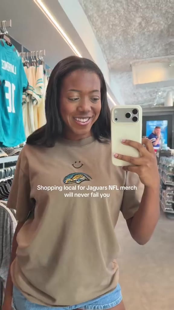 Maya in a Jaguars tee shopping for team merch at a local store